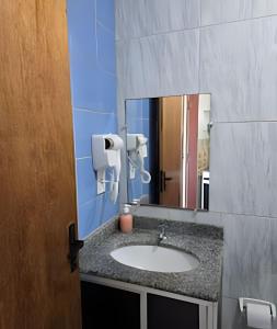 a bathroom with a sink and a mirror at Apartamento interino com vista mar in Natal +13 photos