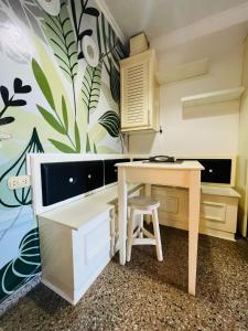 a kitchen with a table and a desk at Carlos Paz Hostel Lodge in Villa Carlos Paz +18 photos
