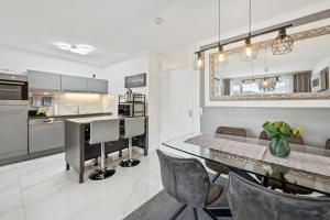 a kitchen and dining room with a table and chairs at Ramoni Apartments - Lichtblick in Enzklösterle +2 photos