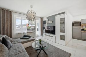 a living room with a couch and a glass table at Ramoni Apartments - Lichtblick in Enzklösterle