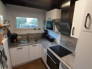 a small kitchen with a sink and a window at Holiday Home Stausee by Interhome in Biersdorf am See