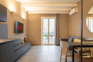a living room with a kitchen and a dining room at Villa Eliseo in Modena