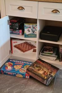 a book shelf filled with games and books at Apartment Kraxler Pärchen by Interhome in Weißenstadt