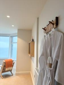 a room with a staircase with a chair and a window at Housel Bay Hotel in Lizard