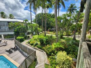 a resort with a swimming pool and palm trees at Marina View in Les Trois-Îlets