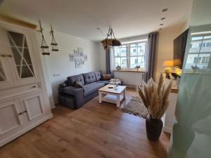 a living room with a couch and a table at Apartment Waldstein Terrassen by Interhome in Weißenstadt