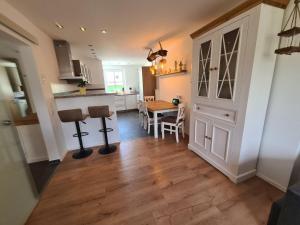 a kitchen and dining room with a table and chairs at Apartment Waldstein Terrassen by Interhome in Weißenstadt