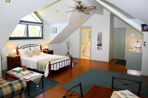 Salamander Bay Bed and Breakfast في سالاماندر باي: غرفة نوم مع سرير وغرفة معيشة