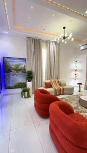 a living room with a red ottoman at 5bedroom duplex self compound in Lekki