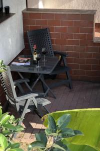 a picnic table with two glasses of wine on a patio at Apartment mit Terrasse by Interhome in Mönkebude +43 photos