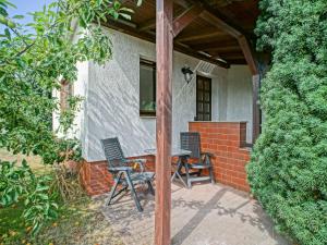 two chairs and a table on a patio at Apartment mit Terrasse by Interhome in Mönkebude