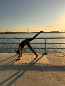 a person doing a yoga pose by the water at Jantawan Hostel in Ban Khlong Chet (2)