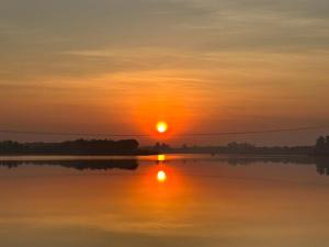 a sunset over a body of water at Jantawan Hostel in Ban Khlong Chet (2) +10 photos