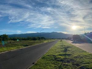 an empty road with the sun in the sky at Casa en la Punta San luis in La Punta