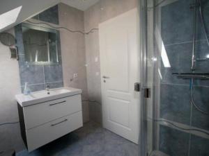 a bathroom with a white sink and a shower at Apartment Tohus - Wigbold by Interhome in Middelhagen