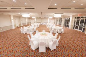 a banquet hall with white tables and white chairs at SEVEN Sebring Raceway Hotel in Sebring +62 photos