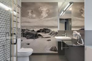 a bathroom with a toilet and a sink at So Stay Bed & Breakfast - Self Check-in in Gdańsk +34 photos