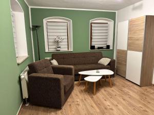 a living room with a couch and a table at Apartment Apartment Wuff by Interhome in Altendorf +6 photos