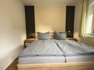 a bedroom with a large bed with two pillows at Apartment Apartment Wuff by Interhome in Altendorf