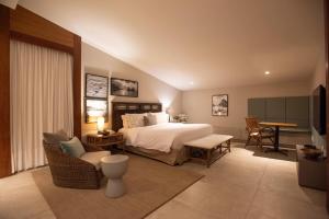 a bedroom with a bed and a table and chairs at Pousada Zé Maria in Fernando de Noronha +52 photos