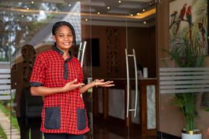 a woman wearing a red shirt and a tie at Kilimont Hotel in Mabire