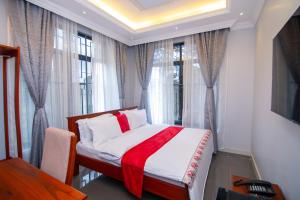 a bedroom with a bed with a red blanket at Kilimont Hotel in Mabire +40 photos