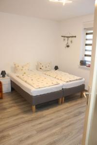 a bed in a white room with a mattress at Apartment Paula by Interhome in Neundorf