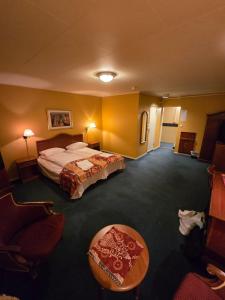 a hotel room with a bed and a table at Heia Hotell in Våler i Solør +20 photos