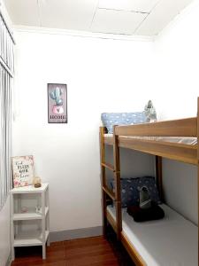 a bedroom with two bunk beds and a white wall at JRC Feel at Home in Puerto Princesa City