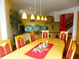 a dining room with a wooden table and chairs at Holiday Home Windrad by Interhome in Auerbach