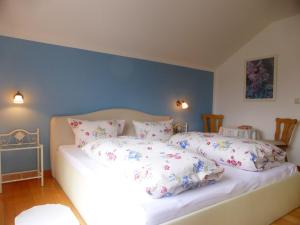 a bedroom with a bed with pillows on it at Holiday Home Windrad by Interhome in Auerbach