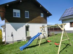 a playground in front of a house with a slide at Holiday Home Windrad by Interhome in Auerbach +22 photos