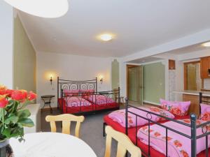 a bedroom with two beds and a table and a tableablish at Holiday Home Windrad by Interhome in Auerbach