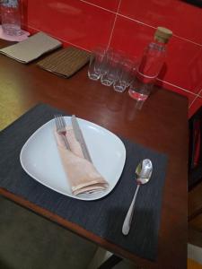 a plate with a napkin and fork and spoon on a table at Hostel Dar Khelifa in Tétouan +35 photos