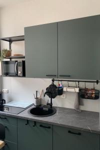 a kitchen counter with a sink and a microwave at Apartment Stadtwohnung by Interhome in Plauen