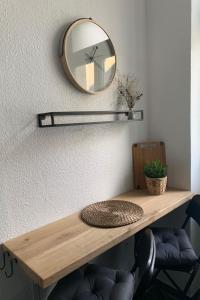 a mirror on a wall with a wooden table at Apartment Stadtwohnung by Interhome in Plauen