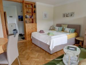 a bedroom with a large bed and a wooden floor at Apartment Wohnung Lilienstein by Interhome in Kurort Rathen