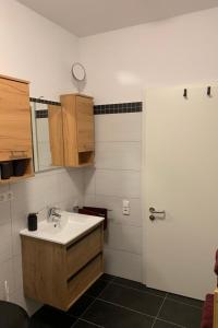 a bathroom with a sink and a mirror at Apartment Stadtwohnung by Interhome in Plauen +8 photos