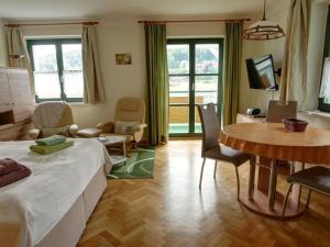 a living room with a bed and a table and chairs at Apartment Wohnung Lilienstein by Interhome in Kurort Rathen