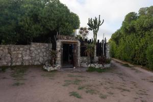 a entrance to a stone house with a stone wall at The Plot West Coast Style Glamping & Accommodation in Jacobs Bay