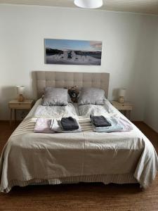 a bedroom with a large bed with towels on it at Villa Toivo in Rovaniemi