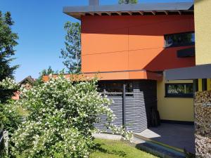 a building with a flowering bush in front of it at Holiday Home mit Wallbox by Interhome in Eibenstock