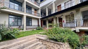 a courtyard of a building with stairs and plants at Iwandaa Boutique Hotel in Nkoanrua