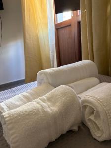 a group of white towels on a bed at Borgo Scorciarini B&B in Piedimonte dʼAlife +8 photos