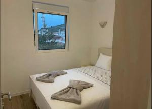a bed with towels on it with a window at Villa Roki in Ravanj