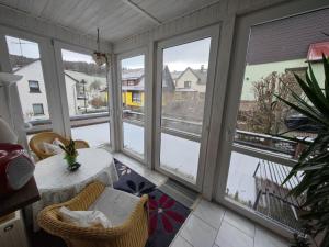 a screened in porch with a table and chairs at Apartment Siegmund by Interhome in Waltershausen