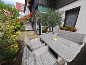 a table and chairs on a patio with flowers at Apartment Siegmund by Interhome in Waltershausen +15 photos