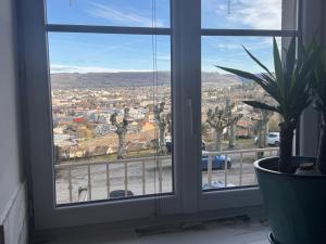 a window with a view of a city at HOME 102 Cosy in Lons-le-Saunier