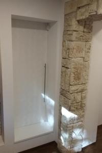 a room with a stone wall next to a door at Apartment Bergnest by Interhome in Bad Gottleuba +27 photos