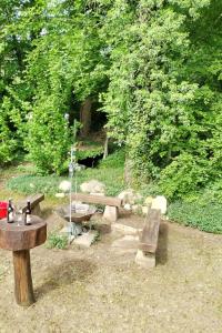 a group of picnic tables and benches in a park at Holiday Home Itzinger by Interhome in Ziesar